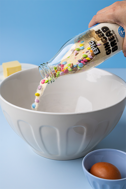 gingerbread mix bottle being poured into mixing bowl